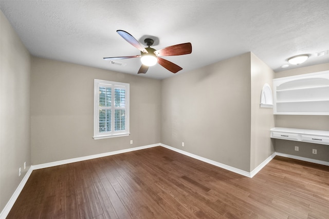 spare room featuring light hardwood / wood-style floors, ceiling fan, and a textured ceiling