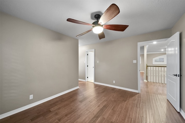 empty room with wood-type flooring and ceiling fan