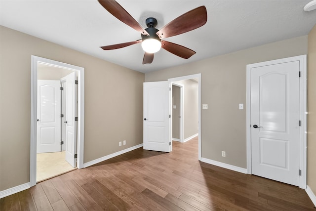 unfurnished bedroom featuring wood-type flooring and ceiling fan