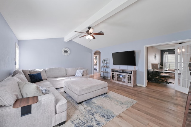 living room featuring ceiling fan, light hardwood / wood-style flooring, and lofted ceiling with beams