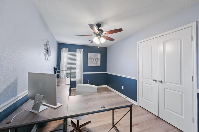 office featuring light hardwood / wood-style floors and ceiling fan