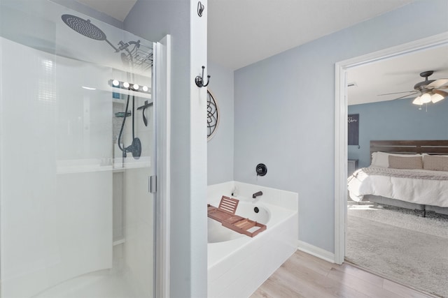 bathroom featuring hardwood / wood-style floors, shower with separate bathtub, and ceiling fan