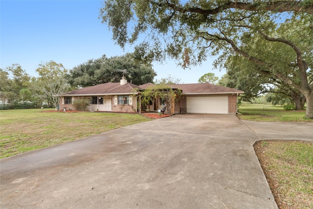 single story home with a porch, a garage, and a front lawn