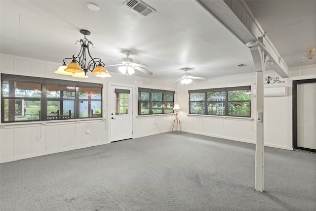 unfurnished living room featuring carpet flooring, ceiling fan with notable chandelier, and a wall mounted AC