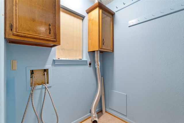 washroom featuring hookup for a washing machine, light tile patterned flooring, cabinets, and hookup for an electric dryer