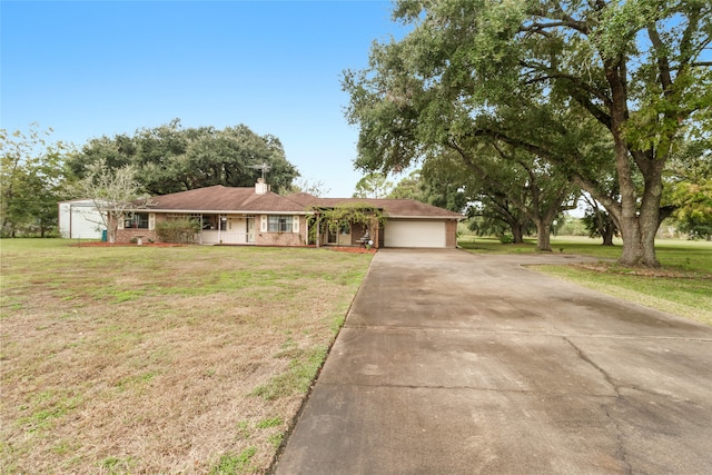 single story home featuring a garage and a front lawn