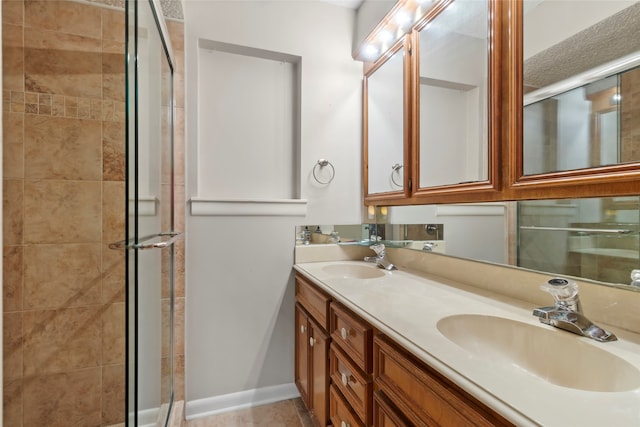 bathroom featuring tile patterned floors, vanity, and walk in shower