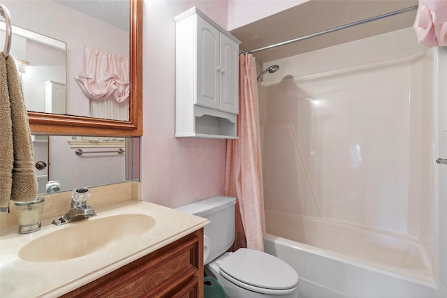 full bathroom featuring vanity, toilet, a textured ceiling, and shower / tub combo