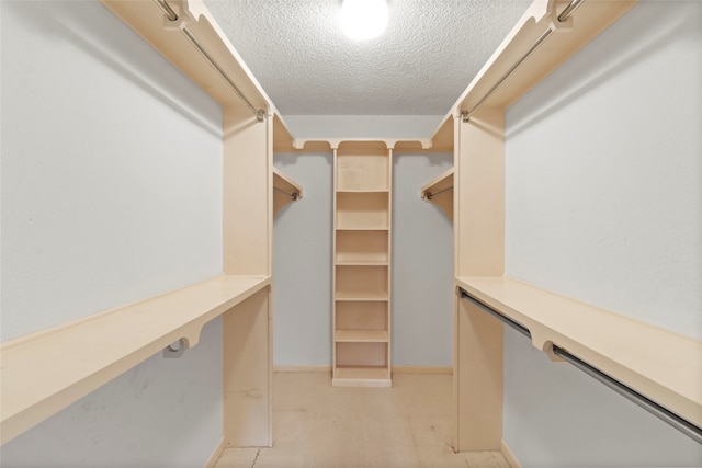 spacious closet featuring built in desk