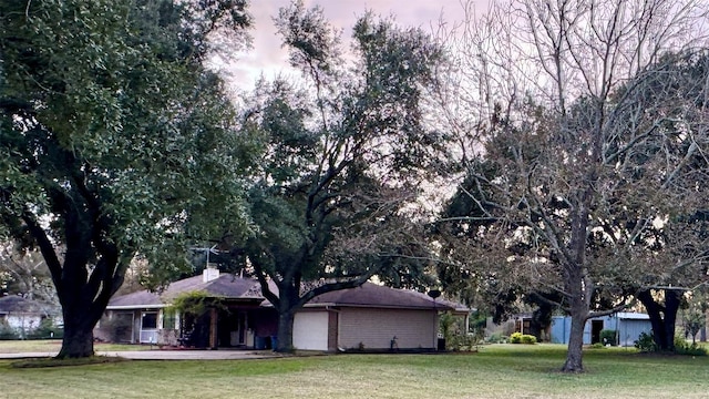 view of front of property with a lawn and a garage