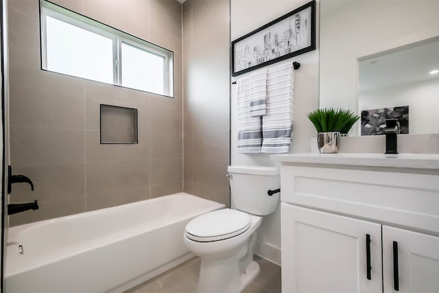 full bathroom with vanity, tiled shower / bath combo, tile patterned floors, and toilet