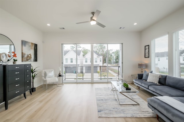 living room with ceiling fan and hardwood / wood-style floors