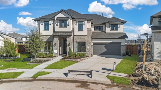 view of front of home featuring a front lawn and a garage