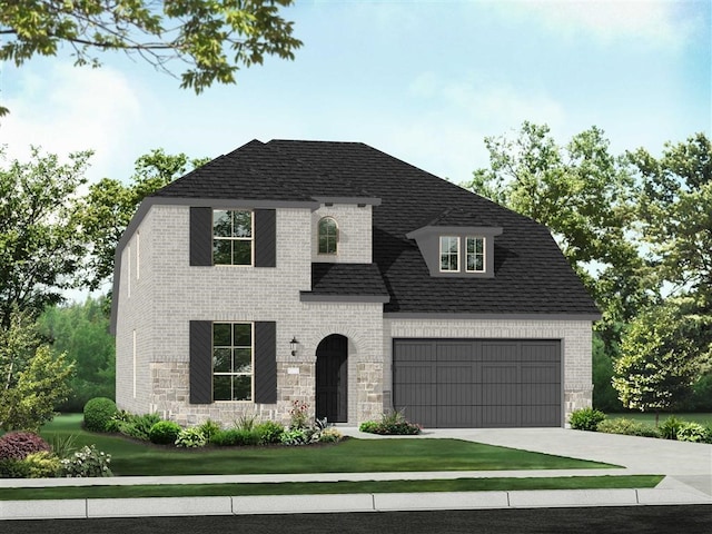 view of front of home featuring a garage and a front yard