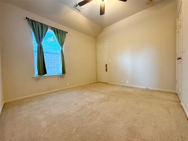 carpeted empty room featuring lofted ceiling and ceiling fan