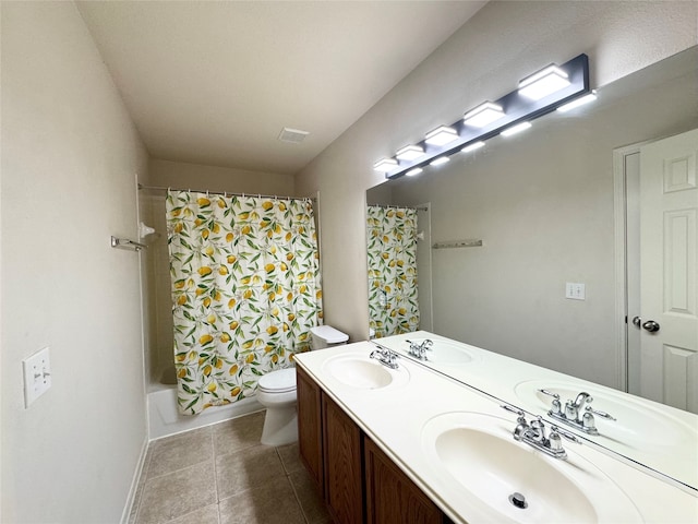 bathroom with tile patterned flooring, a sink, and toilet