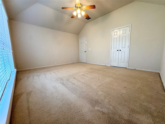 additional living space with carpet, visible vents, vaulted ceiling, ceiling fan, and baseboards