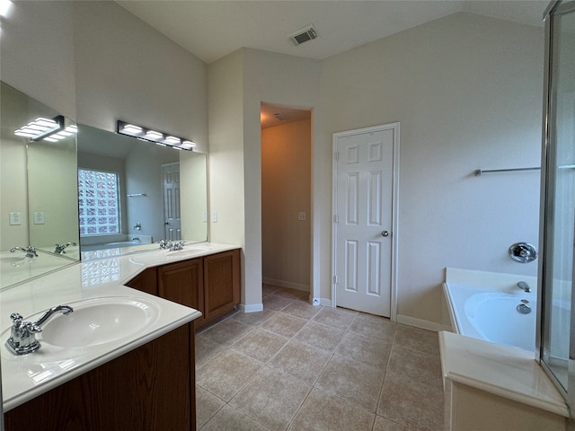 bathroom with a bath, lofted ceiling, tile patterned flooring, and vanity