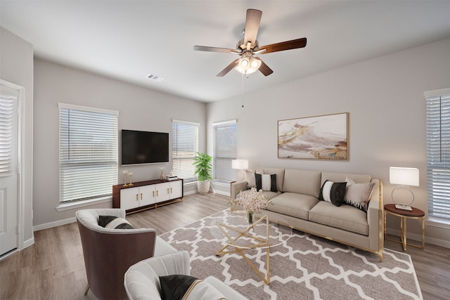 living room with wood-type flooring and ceiling fan