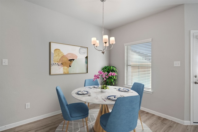 dining room featuring wood-type flooring and a chandelier