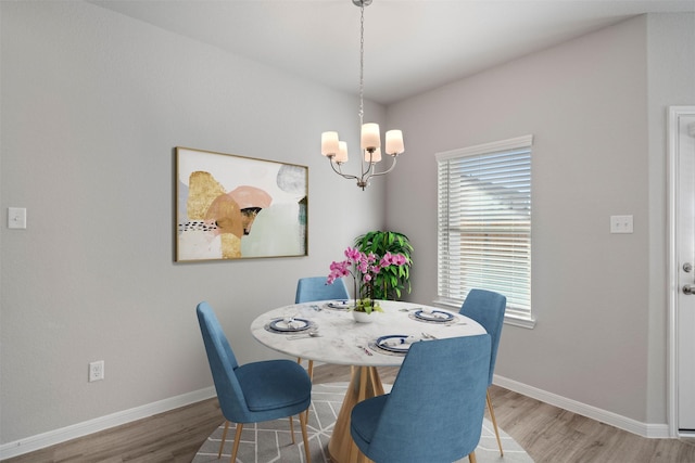 509 Emerald Thicket Trl, Huffman, TX 77336 - dining room with a chandelier, wood finished floors, and baseboards