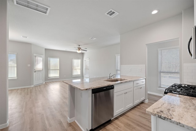 509 Emerald Thicket Trl, Huffman, TX 77336 - kitchen with dishwasher, a sink, backsplash, light wood-style flooring, and recessed lighting