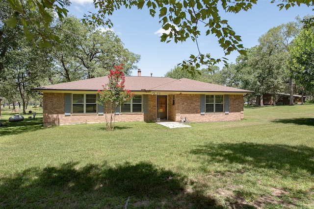 back of property featuring a yard