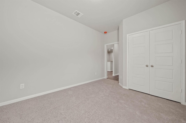 511 Emerald Thicket Ln, Huffman, TX 77336 - unfurnished bedroom with carpet flooring, a closet, and baseboards