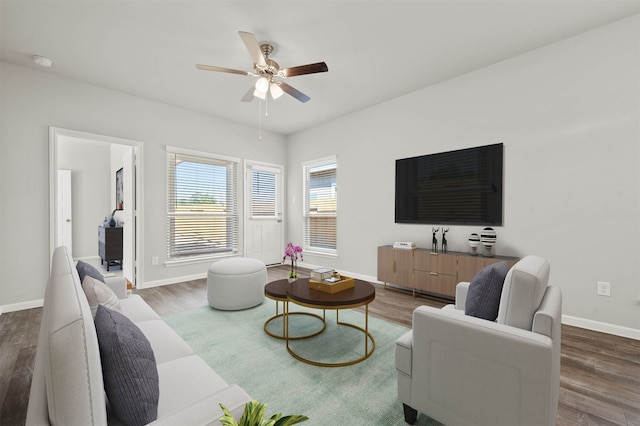 living room featuring dark hardwood / wood-style flooring and ceiling fan