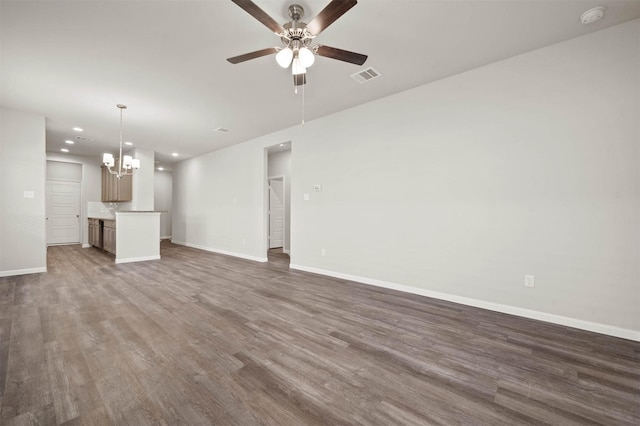 511 Emerald Thicket Ln, Huffman, TX 77336 - unfurnished living room with a ceiling fan, a chandelier, baseboards, wood finished floors, and recessed lighting