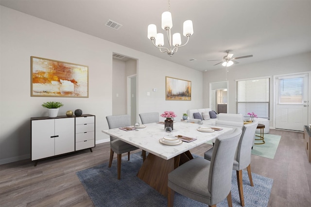 511 Emerald Thicket Ln, Huffman, TX 77336 - dining room with dark wood-style flooring, a chandelier, a ceiling fan, and baseboards
