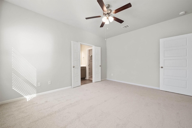 511 Emerald Thicket Ln, Huffman, TX 77336 - unfurnished bedroom featuring light carpet, baseboards, connected bathroom, and ceiling fan