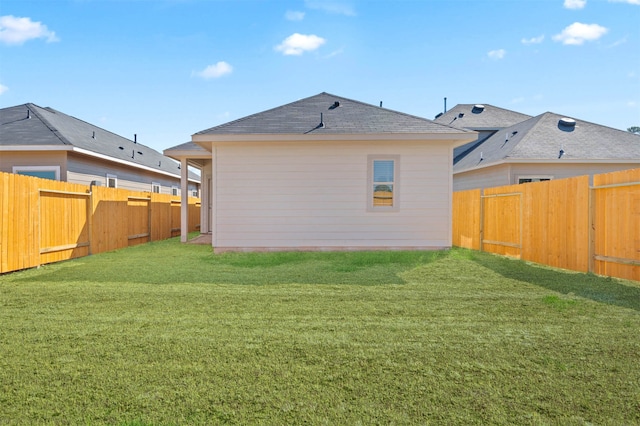 rear view of house with a yard