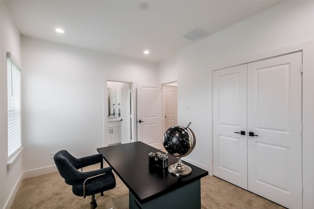 office area featuring light colored carpet