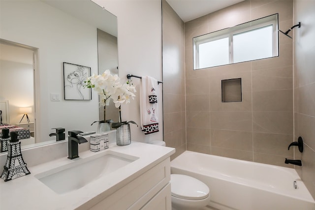 full bathroom with vanity, toilet, and tiled shower / bath combo