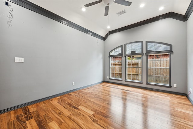 empty room with ceiling fan, lofted ceiling, ornamental molding, and light hardwood / wood-style flooring