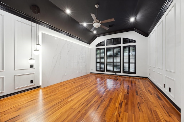 unfurnished room with hardwood / wood-style floors, vaulted ceiling, ceiling fan, and crown molding