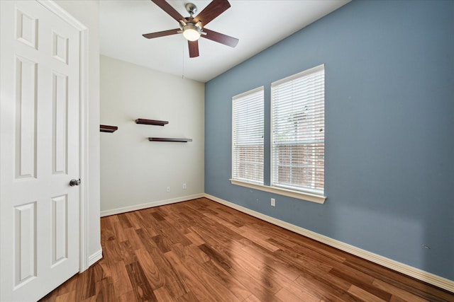 spare room with hardwood / wood-style floors and ceiling fan