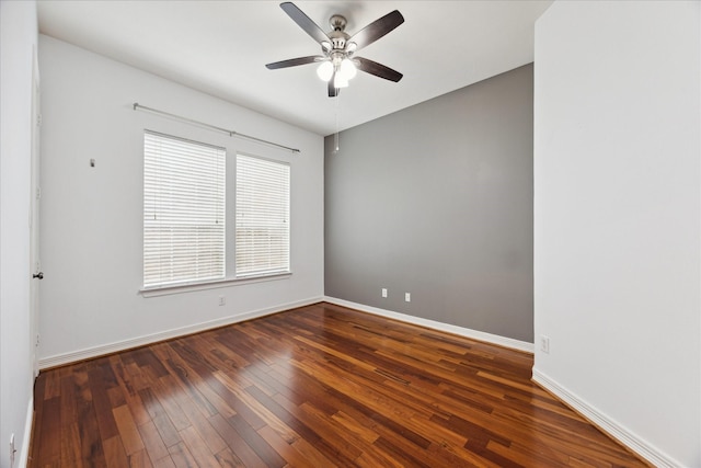 unfurnished room with dark hardwood / wood-style floors and ceiling fan