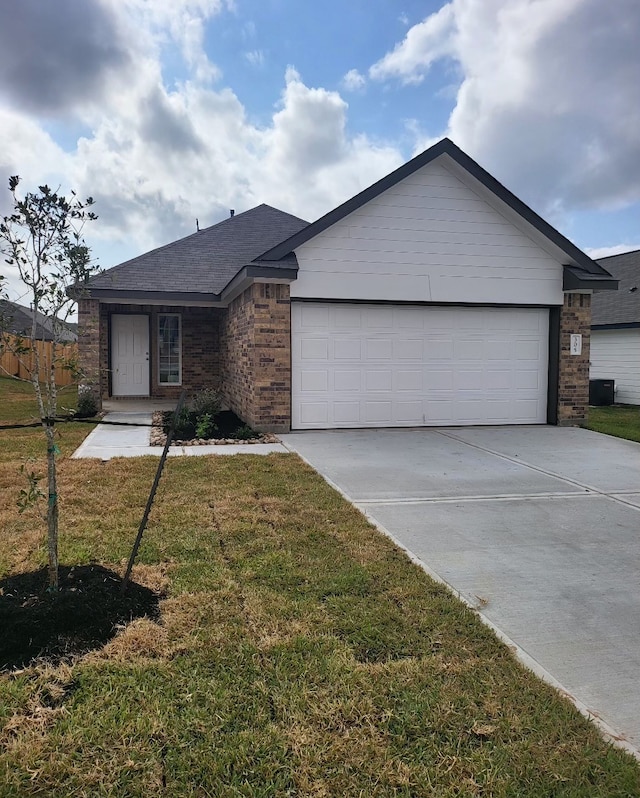 single story home with a garage and a front yard