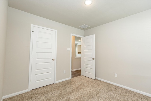 unfurnished bedroom featuring light carpet