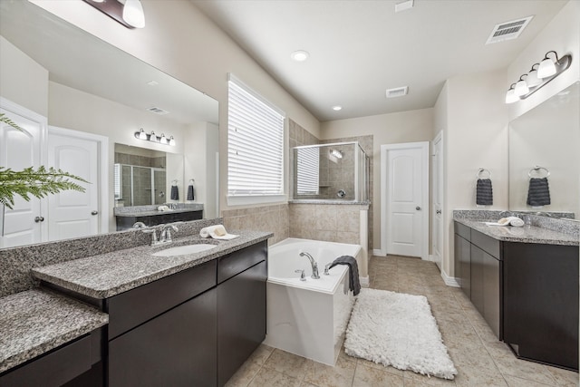 bathroom featuring vanity, shower with separate bathtub, and tile patterned flooring