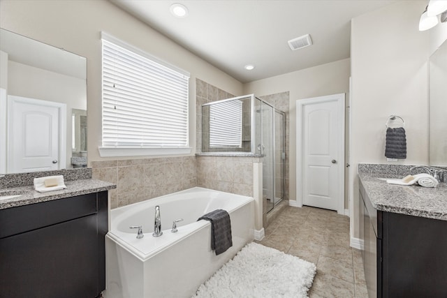 bathroom with vanity, plus walk in shower, and tile patterned flooring