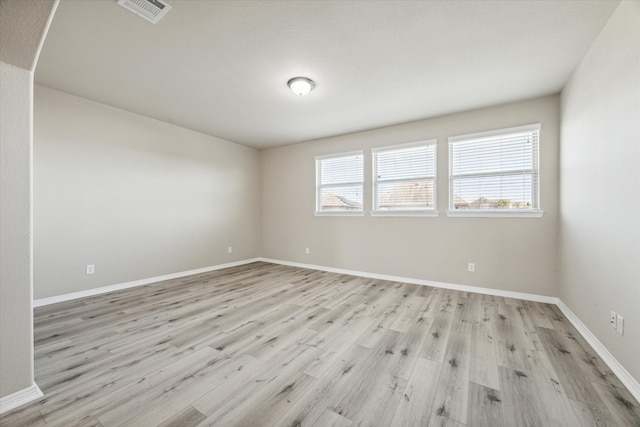 unfurnished room with light wood-type flooring