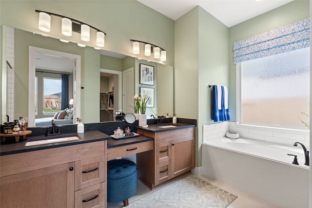 bathroom featuring vanity, tile patterned floors, and a tub