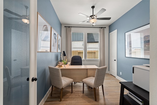 office with ceiling fan and light hardwood / wood-style flooring