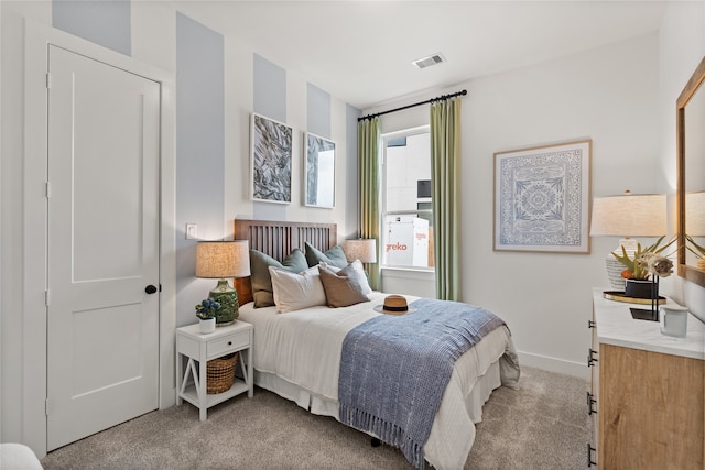 bedroom featuring light colored carpet