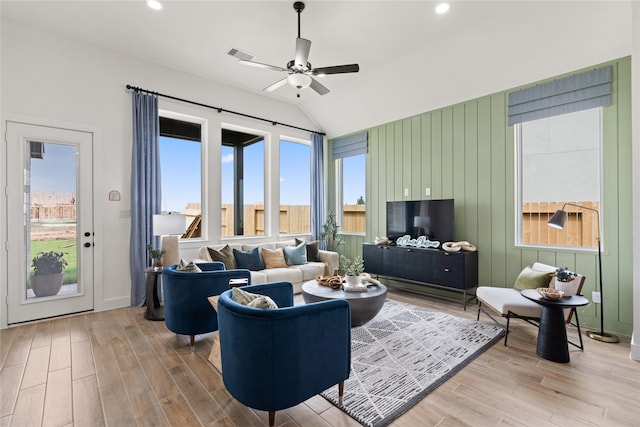 living room featuring ceiling fan and lofted ceiling