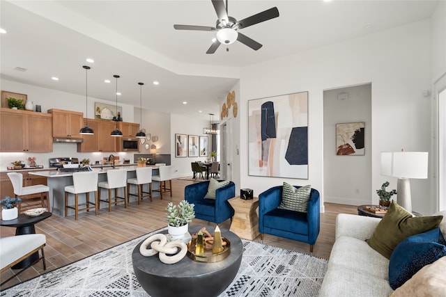 living room with ceiling fan and sink