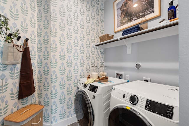 laundry room featuring washing machine and clothes dryer and hardwood / wood-style flooring